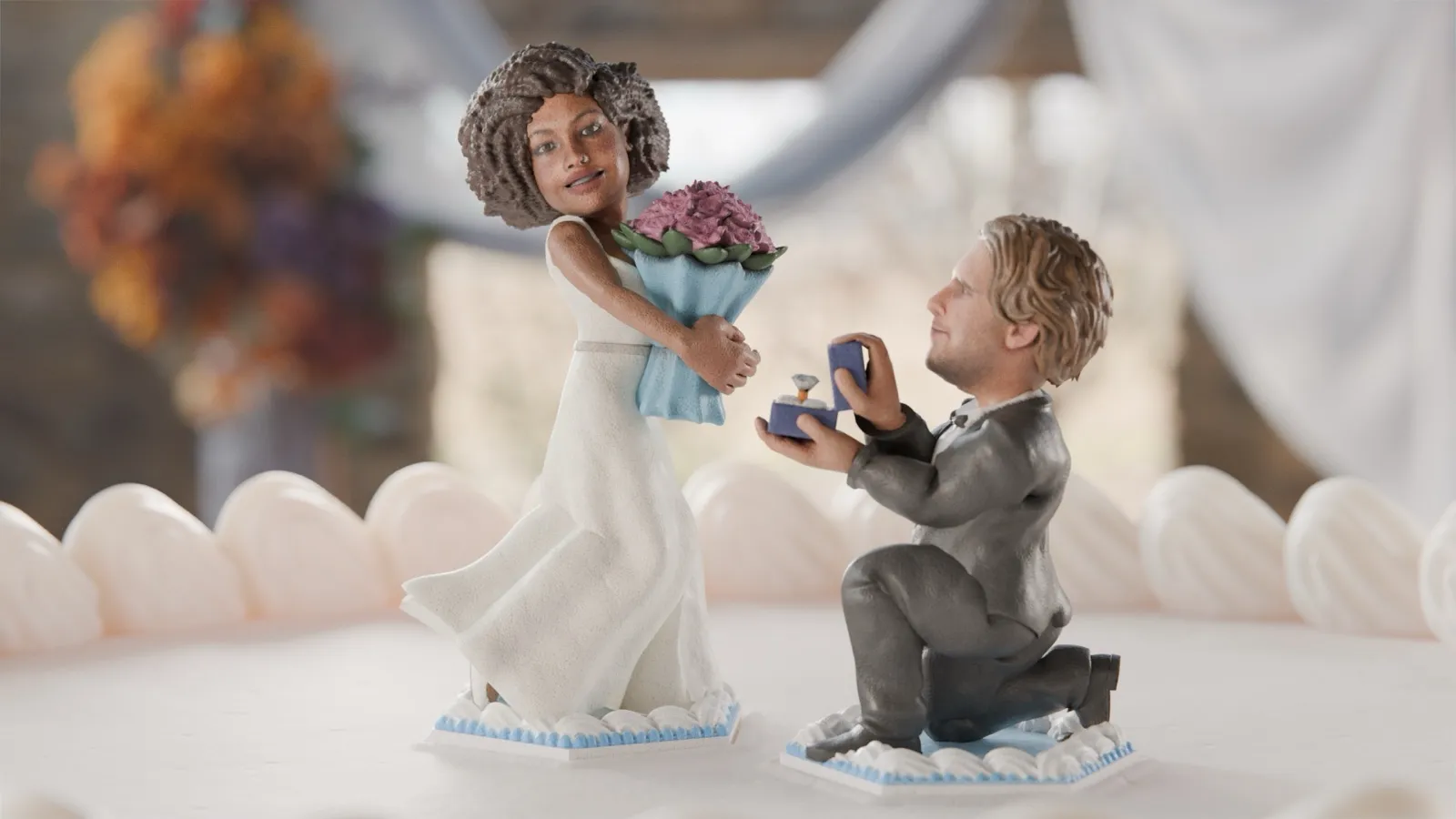 A Minikin cake topper of a proposal: a bride holding flowers and a groom on one knee with a ring